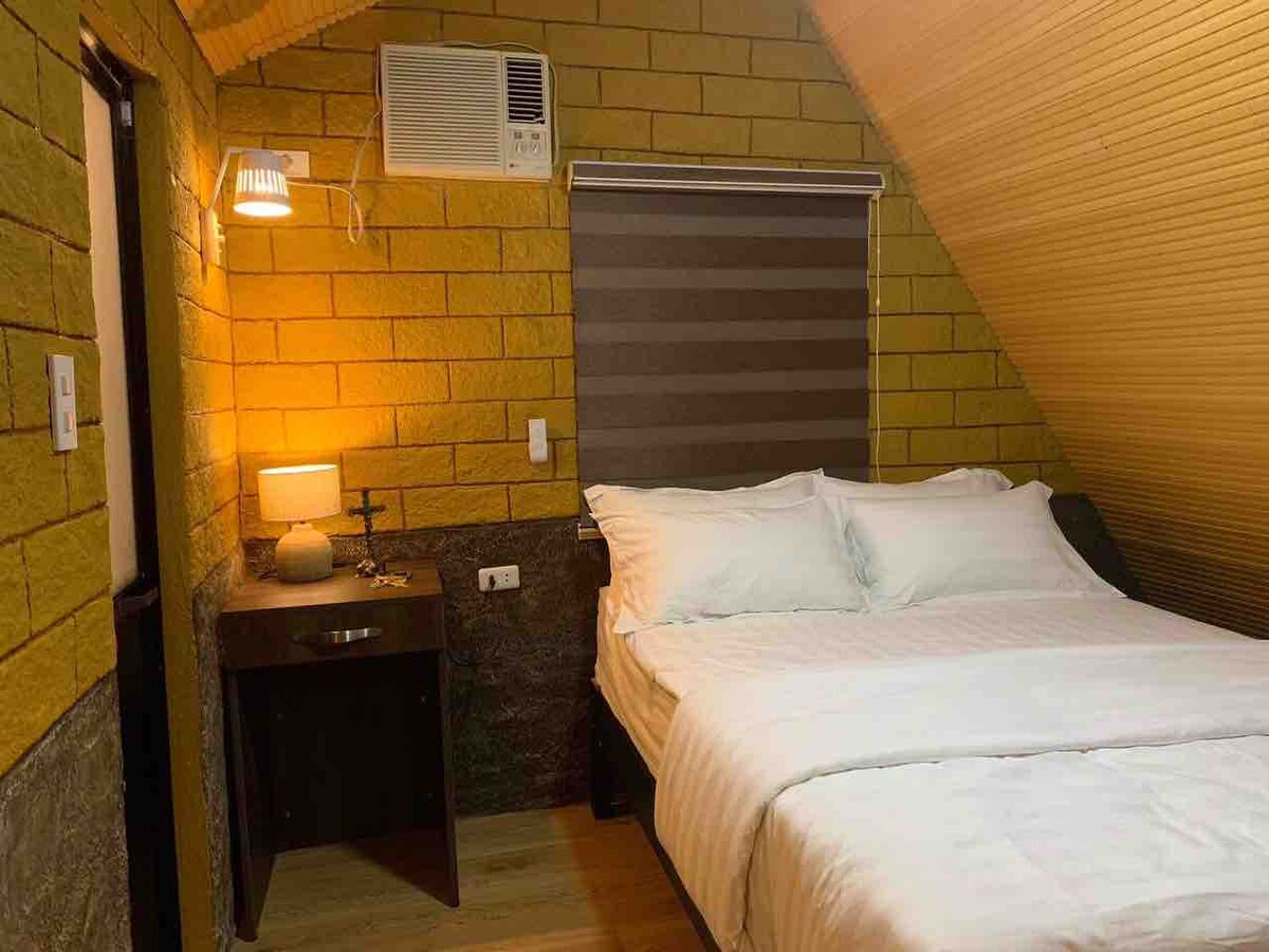 Cozy cabin interior with warm lighting and A-frame ceiling